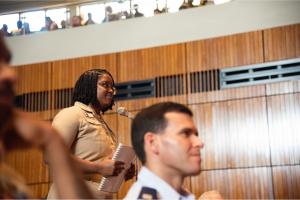 A U.S. Navy student poses a question to former Secretary of Defense Leon Panetta after his presentation during a “Fireside Chat” format Secretary of the Navy Guest Lecture (SGL) at King Hall auditorium, Oct. 8.