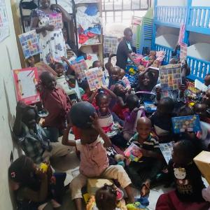 Orphanage kids having big smiles on their faces after opening their gifts