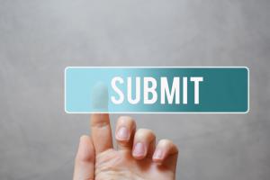 Submit - finger pressing blue transparent button on virtual touchscreen interface on gray background with copy space for text.