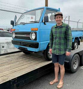 "Customer Ethan with his Daihatsu Hijet sourced directly from Japan through OIWA's auction services. OIWA specializes in importing Japanese mini trucks, including the iconic Daihatsu Hijet, for customers seeking unique vehicles and accessories.