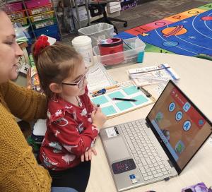 students practices literacy lessons on tablet