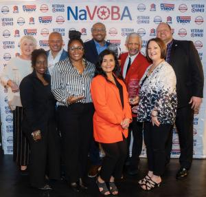 The 2024 Minority Veteran's Business Enterprise Honorees pose for a picture with their crystals alongside the NaVOBA team and event sponsors.