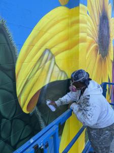 Shawn James Founder of Mural Masters Inc. Painting the Interactive Mural