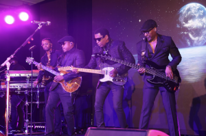 Babyface Performs at the Miracles for Kids ‘2024 Night of Miracles’ Gala and is on stage playing guitar with his back up performers