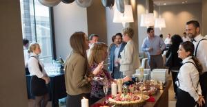 Guests enjoying a special group event in Midtown Manhattan, indulging in gourmet cuisine and fine wines in a sophisticated, elegant setting