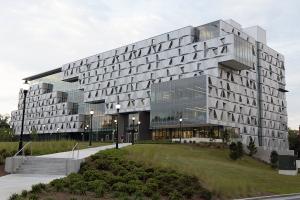 Elevation view of Malachowsky Hall at the University of Florida, highlighting the dynamic shadows and undulating effect created by the volumetric design of aluminum panels.