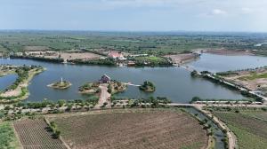 Drone shot of Bharatmata Sarovar in Dudhala, Gujarat, showcasing the vast water reservoir and surrounding landscape dedicated to water conservation and honoring India's heroes.