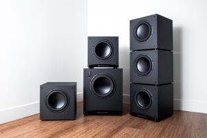 From left to right, an image of the full RSL Speakers Speedwoofer 2024 lineup - One Speedwoofer 10E by itsself, a  Speedwoofer 12S with a 10S MKII stacked on top, and a Speedwoofer 10S MKII with 2 10E's stacked on top. Showing that customers can use just 