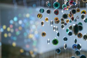 pieces of glass of different colors hanged with nylon