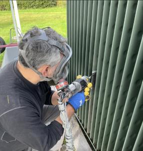 A photo of an operator using the D523 to repair corrosion on a heat exchanger.