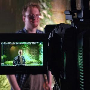 A NewTech Prep student can be seen on the production camera's view finder as he stands in front of the school's new LED wall, purpose-built for Virtual Production