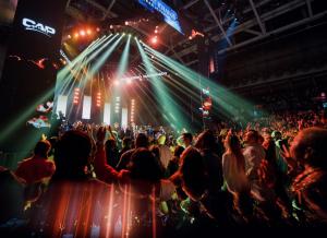 Attendees at the Watsco Center engaged in the Conference of the Apostolic and Prophetic 2024, showcasing a diverse group of individuals participating in prayer and deliverance activities, with a vibrant atmosphere of community and faith.