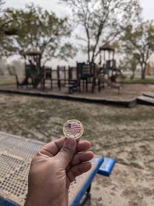 Miguel de Santiago holds Great US Treasure Hunt coin, which survived a flash flood at Enchanted Lands Park in Roswell