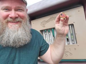 Jared Lyon holds Great US Treasure Hunt coin.