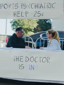 Photo of a man and woman talking at a sport psychiatry booth