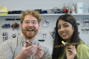 ChompShop co-founders Kausi & Max holding cardboard planes