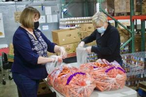 Volunteers prepare Carrots for Snowcap Fill-A-Bag