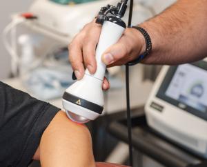 Laser therapy is focused on a patient’s area of concern during a visit to Mandarino Chiropractic.