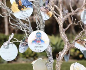 A christmas tree with kids images on it as ornament