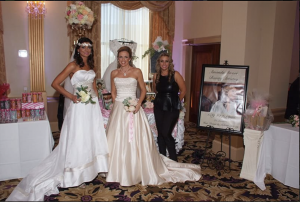 Bridal booth display with models in wedding dresses at Plan It Expo, showcasing gowns and bridal accessories.
