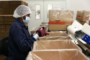 A Haitian factory worker packages life-saving ready-to-use therapeutic food at the Meds and Food for Kids Factory in Cap Haitien