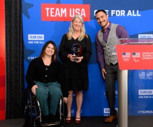 Tyler Carter presents a crystal award to Susan and Jessie