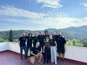 Meet the LearnWise AI Team. Group of people in front of the sky with views of Spain in the sunlight.