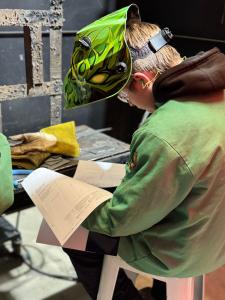 Student reads the Maritime Welding competition project instructions