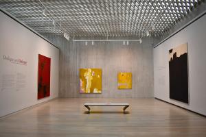 Gallery at the Clyfford Still Museum with large colorful abstract artworks hanging on the walls.