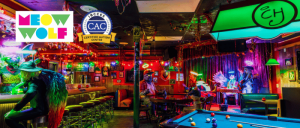 A vibrant, colorful bar scene featuring Meow Wolf's logo and the IBCCES Certified Autism Center™ badge, highlighting their sensory-friendly and inclusive environment.