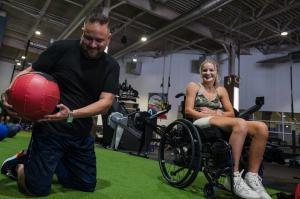 Dr. Edward Alvarez and Makayla Noble in a wheelchair at the Adaptive Training Foundation in Dallas Texas