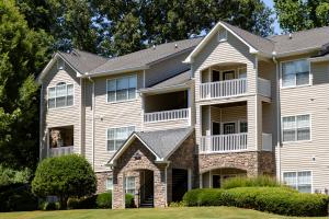 Apartment Building Exterior with Stone Accents and Landscaped Grounds