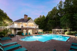 Resident Pool, Sundeck, and Grill Area with Resident Clubhouse in the Background