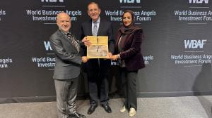 Sinan Tumer, Co-Founder of Naqi Logix Inc. Receiving 1st Place Award.  With the WBAF Chairman Baybars Altuntas and Feryal Abdullah Nass, Founder and Chairwoman of Bahrain Entrepreneurship Organization