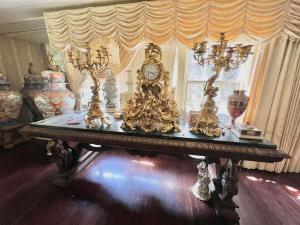 Extraordinary 19th century French Rococo gilt clock garniture set with a rare double-sided porcelain dial signed “Ws. Masse” and a nine-light candelabrum (est. $10,000-$30,000).