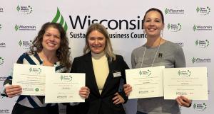 Three women holding certificates at the Wisconsin Sustainable Business Council’s Green Masters Program event, representing New Leaf Paper’s recognition as a Green Master for sustainability excellence.