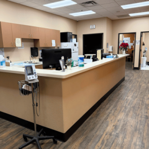 Interior of a medical office reception with computers and medical equipment.