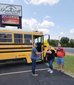 Pastor Zane Brooks with DSS General Manager Heather Helpingstine and DSS Driver/Church Member Mark Saunders, who delivered the donated bus to the church.