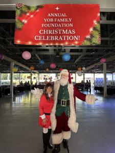 Lisa Yob, Director of Philanthropy for the Yob Family Foundation, shares a joyful moment with Santa Claus before he distributes Christmas gifts to foster children and families in need at the Yob Family Foundation’s 11th Annual Christmas Event.