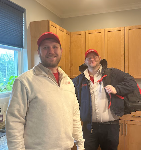 J. Blanton Plumbing technicians working on a sump pump, showcasing the company's expertise in preventing basement flooding and providing after-hours plumbing services in the Chicagoland area.