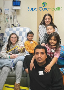 Mother, father, and four children receive donated holiday gifts in hospital room of chronically ill infant