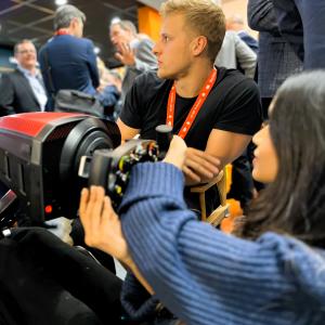 Visitors for a portable full motion formula simulator rental in Munich Germany.