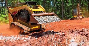 TrackGrip RubberGrip track attachments in use on a compact track loader in an active construction site.