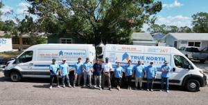 True North Restoration of NW Atlanta's Disaster Response Team stands in front of two vans in Tampa, FL After Hurricane Helene. September 2024.