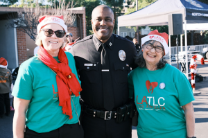 LAPD Captain Keith Green celebrating the ninth annual Los Angeles Trial Lawyers' Charities "Comfort & Joy" event. (L-R: LATLC Treasurer, Chandra Spencer; LAPD Captain Keith Green; LATLC Executive Director, Lissa Zanville)