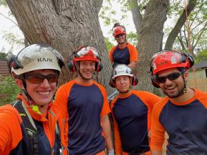 Arborists smiling on site at a tree removal