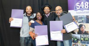 A family hugs to celebrate graduation from the 548 Foundation workforce training program.