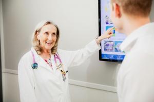 family medicine doctor pointing at a screen