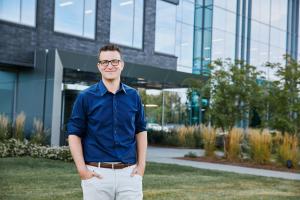 Spencer Patton standing in front of Route Consultant Headquarters in Brentwood Tennessee