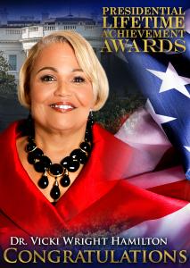 Dr. Vicki Wright Hamilton smiling in a red outfit, honored with the Presidential Lifetime Achievement Award, with the American flag and the White House in the background.